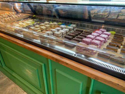 a display case filled with different types of pastries at Travelodge Hotel Auckland Wynyard Quarter in Auckland