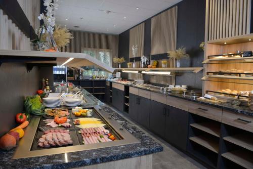 a large kitchen with a buffet of food at Sure Hotel by Best Western Hilden-Düsseldorf in Hilden