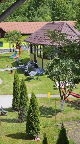 einen Park mit Spielplatz mit Rutsche und Bäumen in der Unterkunft Vila Drumetului in Comarnic