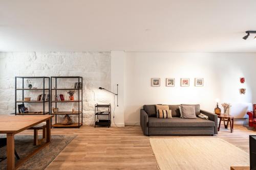 a living room with a couch and a table at VIVA Boavista Vintage House in Porto