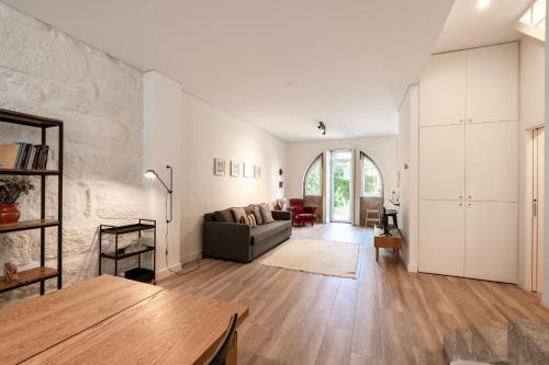 a living room with a couch and a table at VIVA Boavista Vintage House in Porto