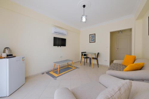 a living room with a couch and a table at Larimar Suite Hotel in Oludeniz