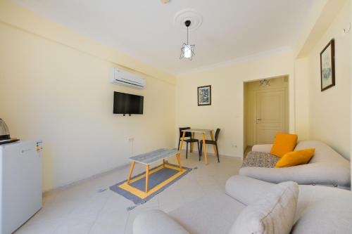 a living room with a couch and a table at Larimar Suite Hotel in Oludeniz
