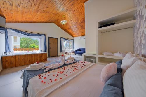 a large bedroom with a large bed with red hearts on it at Larimar Suite Hotel in Oludeniz