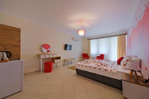 a bedroom with a bed and a desk in a room at Larimar Suite Hotel in Oludeniz