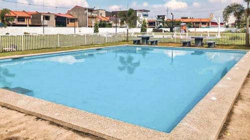 an empty swimming pool with blue water at Rics Staycation at Urban Deca Homes Marilao, Bulacan in Marilao