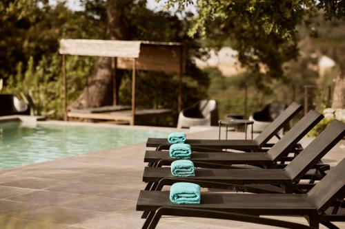 a group of chairs with towels on them next to a pool at Villa Fuerte Chania - Including Two 7-seater Vans, Airport Shuttle, Breakfast in Alikianós
