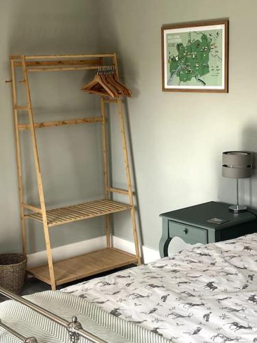 a room with a book shelf next to a bed at Cotswold Retreat in Cheltenham
