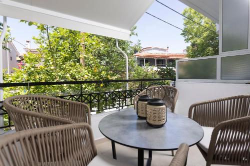 eine Terrasse mit einem Tisch und Stühlen auf dem Balkon in der Unterkunft Anastasia Studios Hanioti in Chaniotis