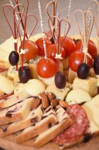 a plate of food with cheese and tomatoes and nuts at Hotel "Srbija Tis" in Zaječar
