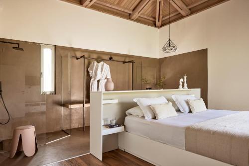 a bedroom with a large bed and a shower at Villa Fuerte Chania - Including Two 7-seater Vans, Airport Shuttle in Alikianós