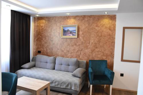 a living room with a couch and two chairs at Hotel "Srbija Tis" in Zaječar