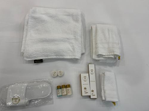 a bathroom with towels and other items on a counter at Hamdan Hotel and Resort in Murree