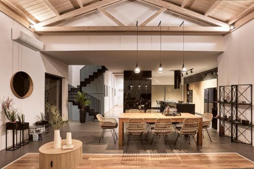 a dining room with a table and chairs at Villa Fuerte Chania - Including Two 7-seater Vans, Airport Shuttle in Alikianós