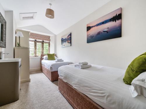 um quarto com 2 camas individuais e uma casa de banho em The Oaks em Windermere
