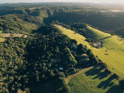 an aerial view of a field with trees at Firefly Falls in Plettenberg Bay