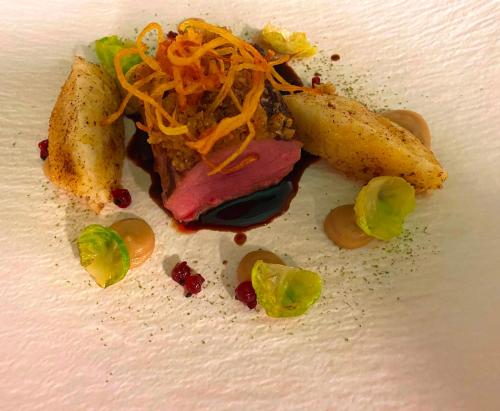 a piece of food on a white plate at Hotel Schwengerer in Mönichwald