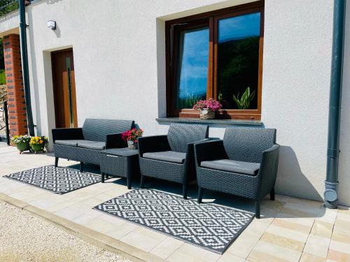a group of chairs sitting on a patio at GÓRSKA CISZA - Duży, komfortowy, wyjątkowy Apartament in Stronie Śląskie
