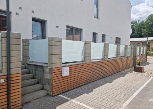 a row of mirrors on a fence in front of a building at Apartmán POD ROTUNDOU in Skalica