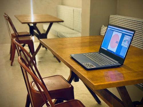 a laptop computer sitting on top of a wooden table at Sun Smart Hotel in Recife