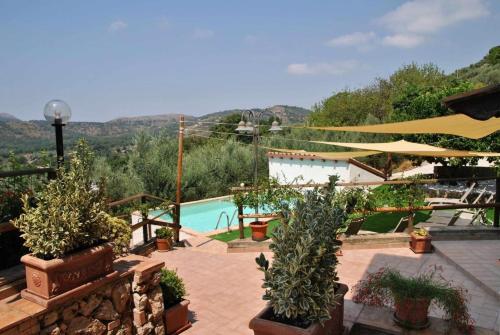 a patio with a swimming pool and some plants at Casale del Principe Itri in Itri