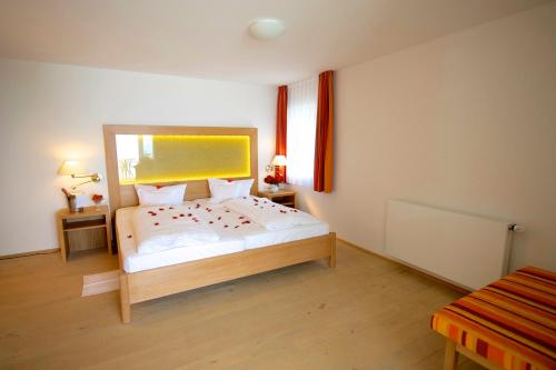 a bedroom with a bed with a large mirror at Seehotel OFF in Meersburg