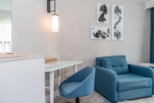 a room with a blue chair and a table at Royal Wings Hotel in Lara