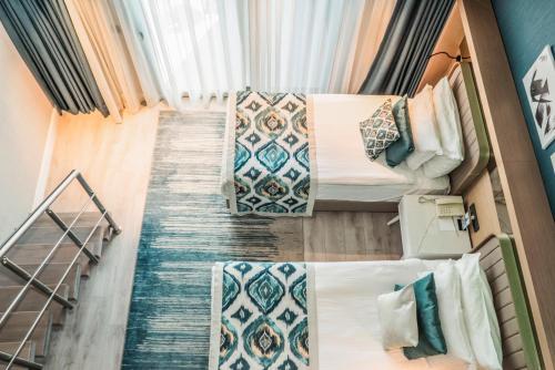 a view of two beds in a room at Royal Wings Hotel in Lara