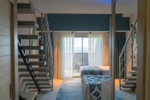 a room with two bunk beds and a staircase at Royal Wings Hotel in Lara