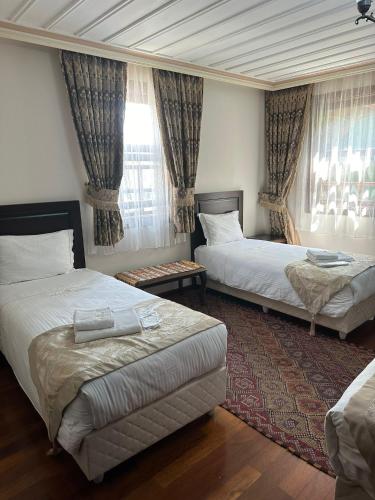 a hotel room with two beds and a window at Bender Hotel in Istanbul