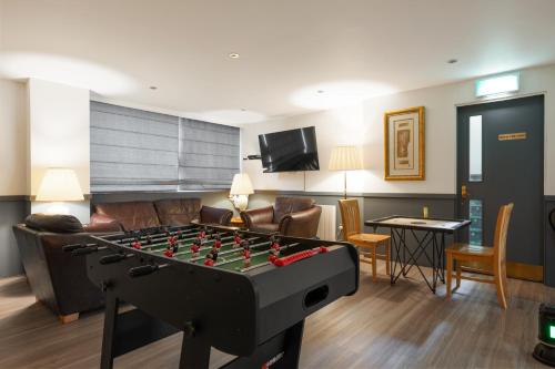 a living room with a foosball table in a living room at Onich Hotel & Lochside Beach Pods in Onich