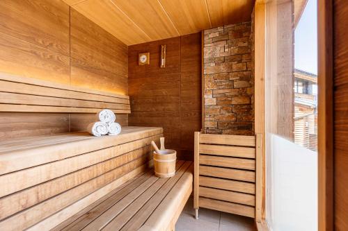 a sauna with wooden walls and wooden flooring at Alpenchalets Reiteralm by ALPS RESORTS in Schladming