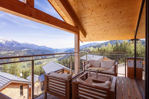 a balcony with chairs and a view of mountains at Alpenchalets Reiteralm by ALPS RESORTS in Schladming