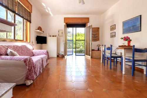 a living room with a couch and a table at Villa Fabiana in Torre dell'Orso