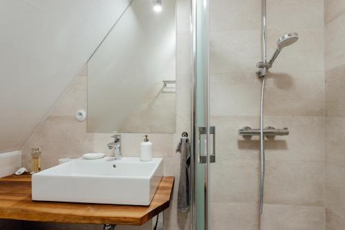 a bathroom with a sink and a shower at Opera apartments in Banská Štiavnica