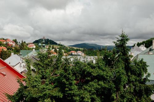 a view of a town with trees and buildings at Opera apartments in Banská Štiavnica