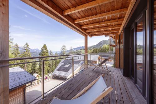 a balcony with a view of the mountains at Alpenchalets Reiteralm by ALPS RESORTS in Schladming