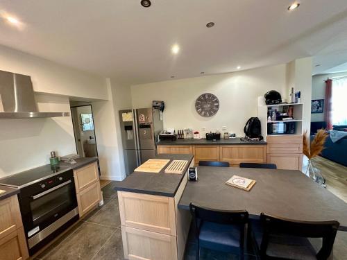 a kitchen with a large island in the middle at Chez Gus - 10 personnes - BCLA in Arnage