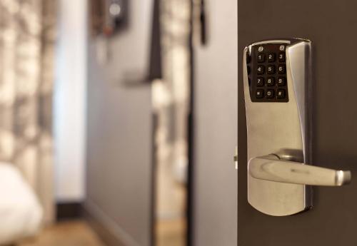 a close up of a door with a remote control at B&B HOME Paris Mairie de Saint-Ouen in Saint-Ouen
