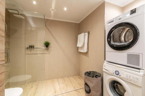 a laundry room with a washer and dryer at Lilium Luxury Apartment in Igoumenitsa