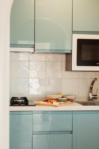 a kitchen with blue cabinets and a counter top at Los Bungalows Del Arenal in Jávea