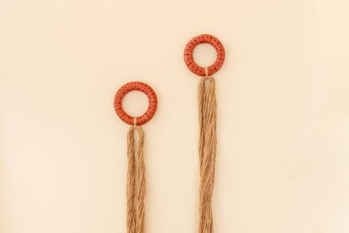 two mens earrings with tassels on a white background at GuestReady - Conde das Alcáçovas in Paço de Arcos