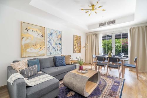 a living room with a couch and a table at GuestReady - Springs Serenity near Golf Club in Dubai