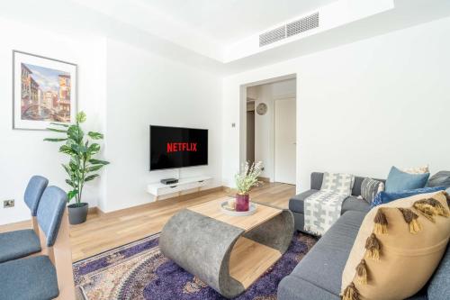 a living room with a couch and a tv at GuestReady - Springs Serenity near Golf Club in Dubai
