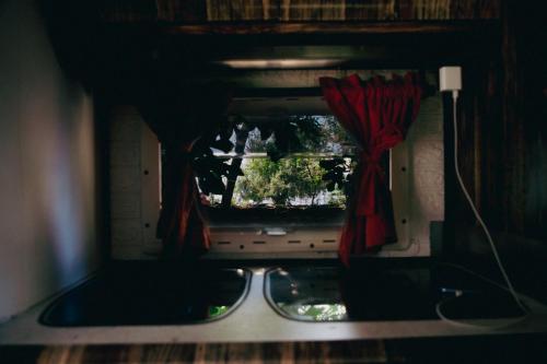 a view of a window with a red curtain at Montenegro Camper in Podgorica