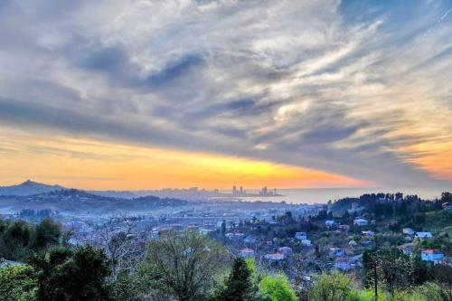 a view of a city at sunset at Turo House in Batumi