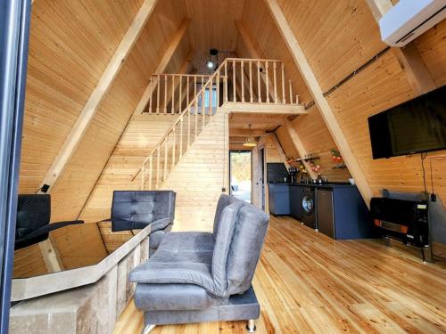 a living room with a chair and a staircase at Turo House in Batumi