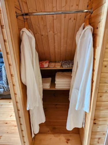 a sauna with white towels hanging on a rack at Turo House in Batumi