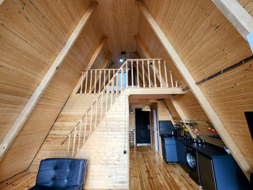 an attic with a staircase in a house at Turo House in Batumi