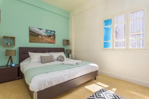 a bedroom with a bed and a window at Mikaella's Cozy 1-BR with 24-7 Electricity in Beirut